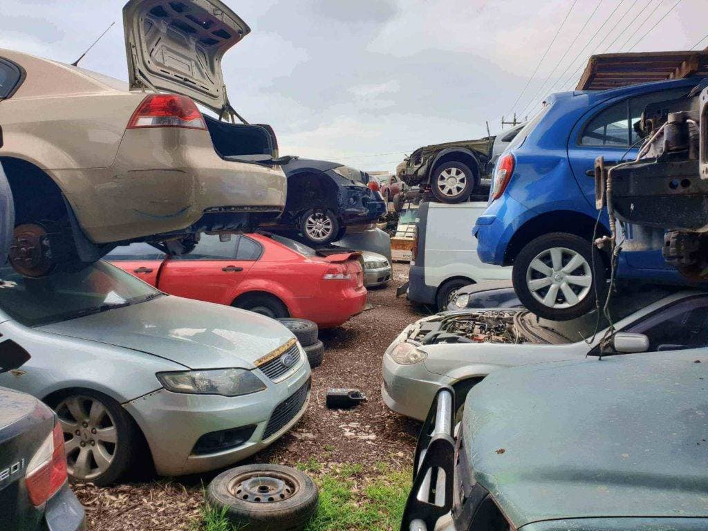 Cars waiting to be recycled at a wrecking yard